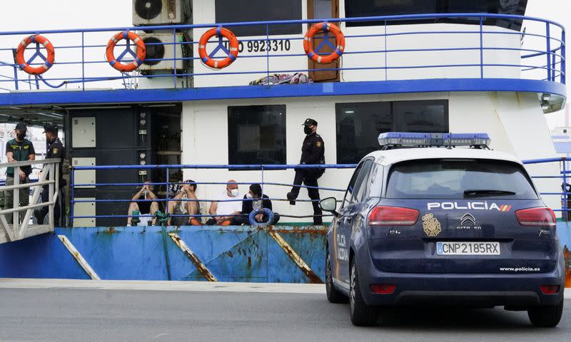 Police officers guard four detainees on the fishing boat "AKT-1", in the island of Gran Canaria