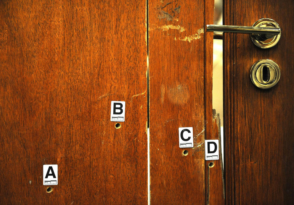 The bullet-riddled toilet door through which Oscar Pistorius shot and killed his girlfriend Reeva Sttenkamp is exhibited in court in Pretoria, South Africa, Monday, April 14, 2014. The chief prosecutor in the murder trial of Oscar Pistorius on Monday accused him of tailoring his version of how he killed his girlfriend to fit evidence at the scene, exhaustively listing alleged inconsistencies in the athlete's account of the fatal shooting of Reeva Steenkamp. (AP Photo/Antoine de Ras, Pool)