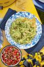 <p>Trust us: Guac and chips make a <em>great</em> appetizer while guests are getting ready for the meal. Finish off this traditional avocado mixture with an additional sprinkle of toasted seeds, and serve with your favorite tortilla chips. For added flair (and flavor) mix it up the traditional way, in a Mexican granite mortar and pestle, called a molcajete.</p><p><strong><a href="https://www.countryliving.com/food-drinks/a24275293/pepita-guacamole-recipe/" rel="nofollow noopener" target="_blank" data-ylk="slk:Get the recipe;elm:context_link;itc:0;sec:content-canvas" class="link ">Get the recipe</a>.</strong></p><p><strong><a class="link " href="https://www.amazon.com/Granite-Mortar-Pestle-Set-Molcajete/dp/B07DFG7BT3/?tag=syn-yahoo-20&ascsubtag=%5Bartid%7C10050.g.34473510%5Bsrc%7Cyahoo-us" rel="nofollow noopener" target="_blank" data-ylk="slk:SHOP MOLCAJETES;elm:context_link;itc:0;sec:content-canvas">SHOP MOLCAJETES</a><br></strong></p>