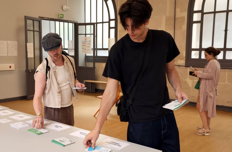 Voters line up to cast their ballot during the first-round of parliamentary elections in Paris, France, on Sunday. Photo by Maya Vidon-White/UPI