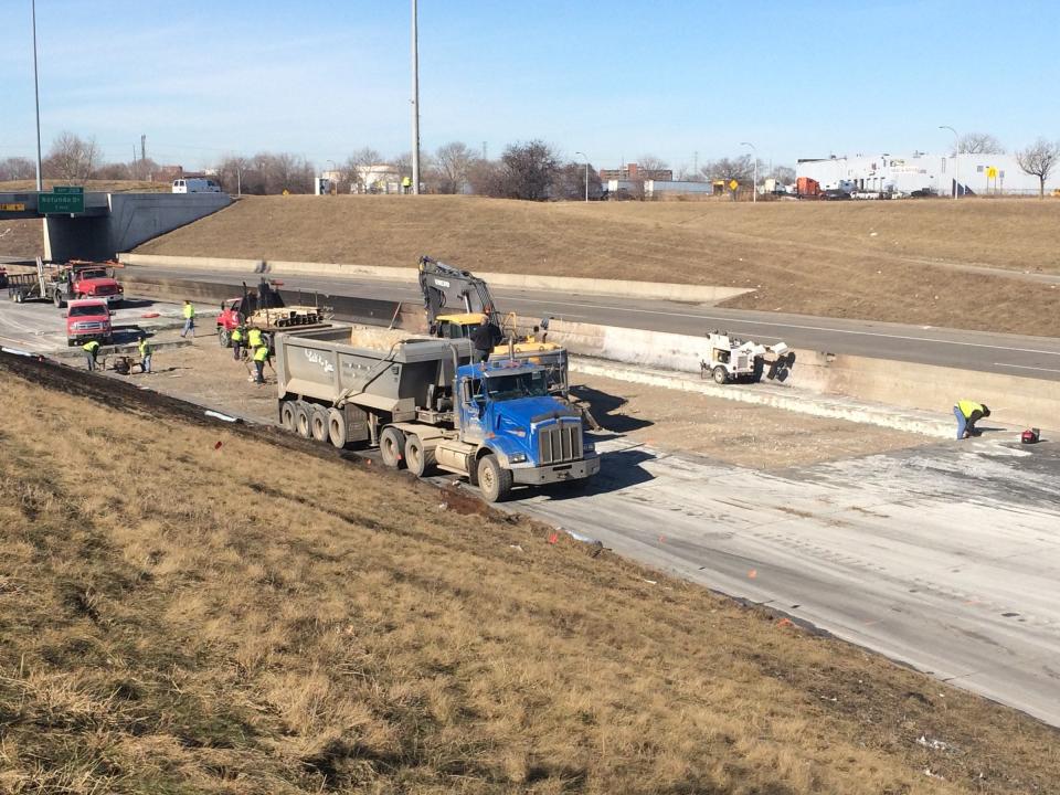 Crews cut out a large section of pavement from eastbound I-94 on Thursday, March 12, 2015 after a fuel tanker carrying 13,000 gallons exploded into multiple fireballs on Wednesday, March 11, 2015, on the border of Dearborn and Detroit.