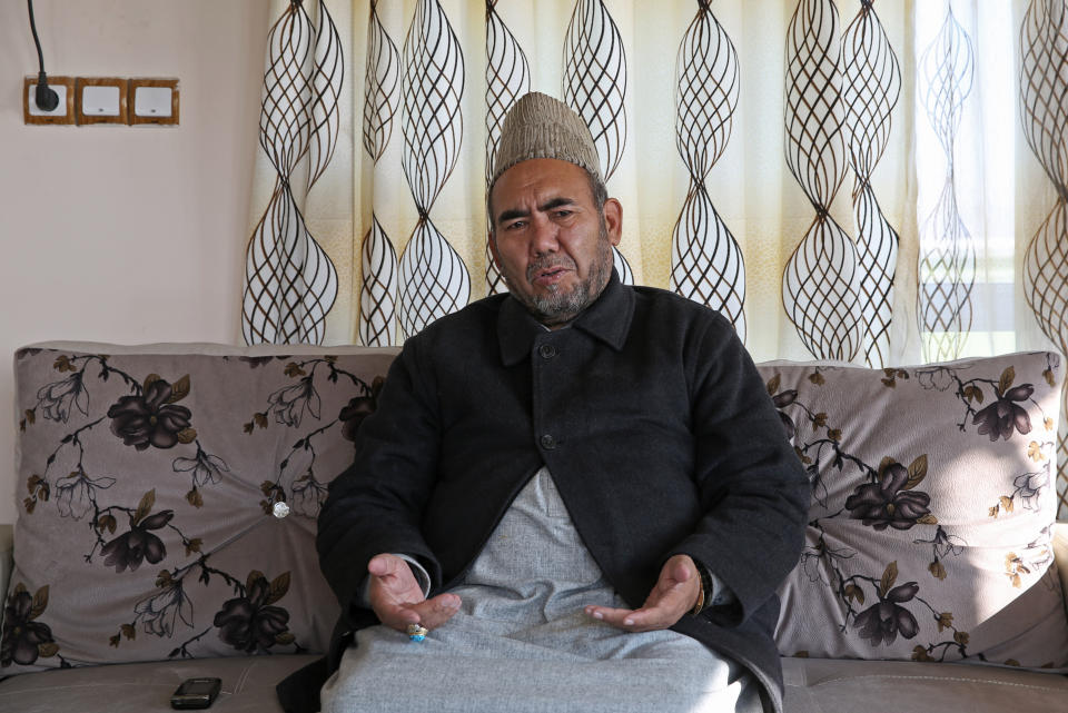 In this Thursday, Jan. 9, 2014 photo, Haji Ramazan Hussainzada, a Hazara community leader, talks during an interview with the Associated Press in Kabul, Afghanistan. Locals call it "Death Road." The 30-kilometer (18 mile) stretch of road heading west from here has seen so many beheadings, kidnappings and other Taliban attacks in recent years that it's become a virtual no man's land, cutting off the Hazara minority from their homeland in Afghanistan's rugged mountainous center. (AP Photo/Massoud Hossaini)