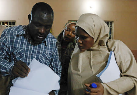 Independent National Electoral Commission (INEC) officials check documents prior to polls opening for the presidential election at the Yola North Local Government Area office in Adamawa State, Nigeria February 22, 2019. REUTERS/Nyancho NwaNri