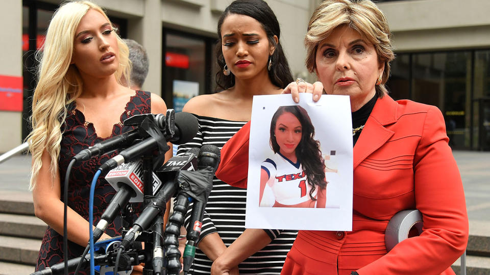 Former Houston Texans cheerleaders Hannah Turnbow and Angelina Rosa watch Attorney Gloria Allred hold up a photo as she hosts a press conference outside National Football League headquarters on June 22, 2018 in New York City. (Photo by Mike Coppola/Getty Images)