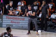 Miami Heat's Meyers Leonard, right front, cheers on his team during the first half of an NBA conference final playoff basketball game against the Boston Celtics on Saturday, Sept. 19, 2020, in Lake Buena Vista, Fla. (AP Photo/Mark J. Terrill)