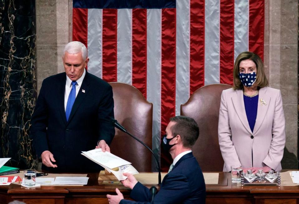 Vice President Mike Pence and House Speaker Nancy Pelosi preside over a Joint session of Congress to certify the 2020 Electoral College results on Jan. 6, 2021. / Credit:  J. SCOTT APPLEWHITE/POOL/AFP via Getty Images