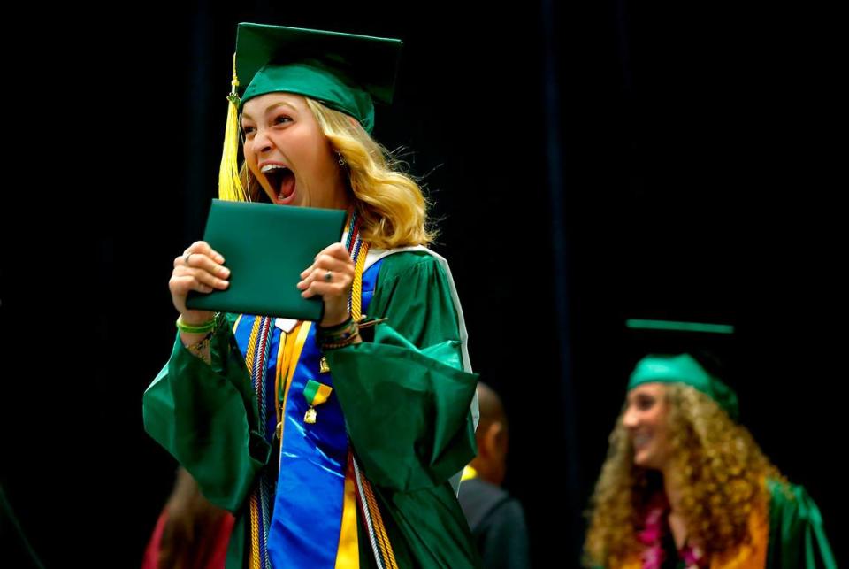 Richland High graduate Rachel Higbee celebrates on stage at the Toyota Center after receiving her diploma during the school’s 110th commencement. 