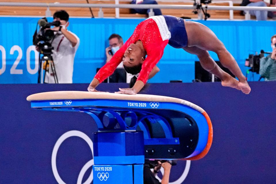 Simone Biles competes on the vault before withdrawing from Tuesday's team final.