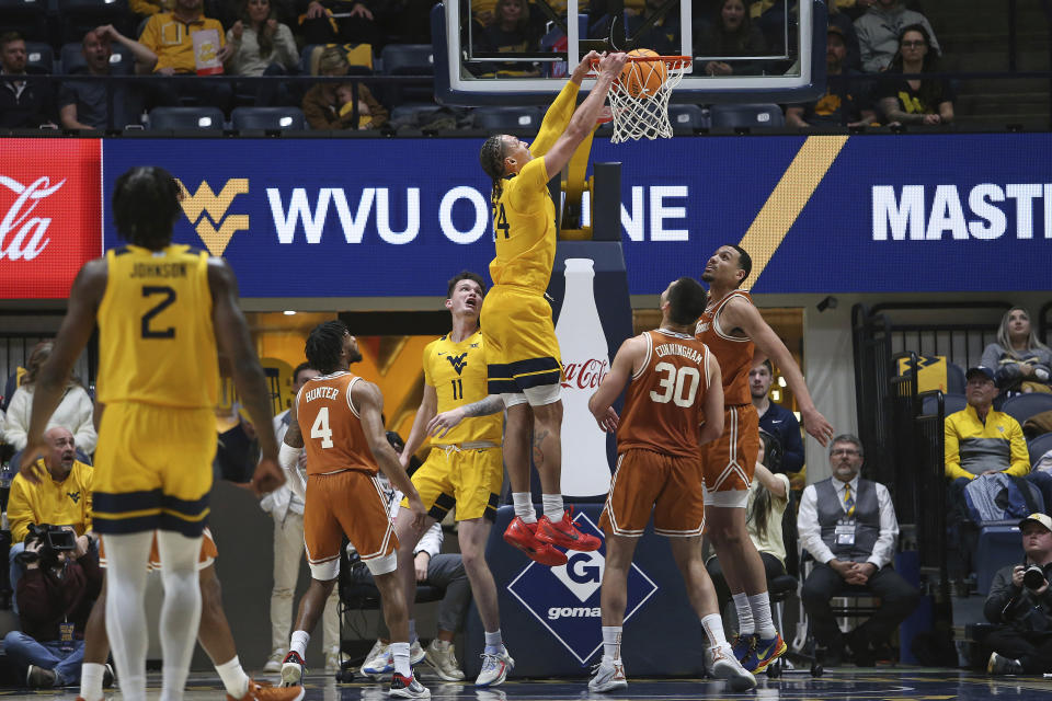 West Virginia forward Patrick Suemnick (24) dunks against Texas during the second half of an NCAA college basketball game on Saturday, Jan. 13, 2024, in Morgantown, W.Va. (AP Photo/Kathleen Batten)