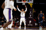 Los Angeles Lakers guard Russell Westbrook (0) reacts after forward LeBron James (6) scoring a three-point basket against the Memphis Grizzlies during the first half of an NBA basketball game in Los Angeles, Sunday, Oct. 24, 2021. (AP Photo/Ringo H.W. Chiu)