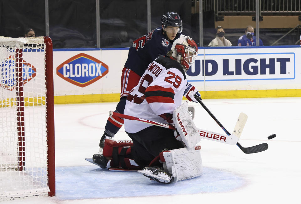 New York Rangers' Ryan Strome (16) attempts to deflect a second-period shot past New Jersey Devils goalie Mackenzie Blackwood (29) during an NHL hockey game Thursday, April 15, 2021, in New York. (Bruce Bennett/Pool Photo via AP)