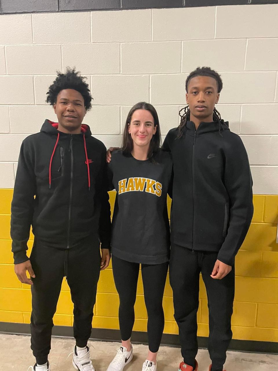 Manual junior Dietrich Richardson, far right, poses for a picture with Iowa all-American Caitlin Clark, middle, and Peoria High junior Leshawn Stowers at the Iowa-Wisconsin men's basketball game on Saturday, Feb. 17 in Iowa City, Iowa.