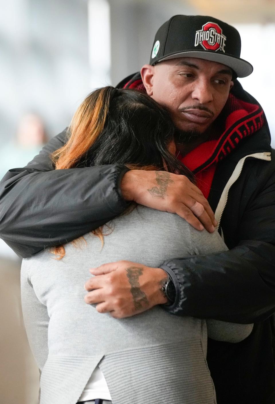 Feb 16 2024; Columbus, Ohio, USA; Tamala Payne embraces her brother Ernest Payne Jr. outside of the courtroom with her family at the trial of Michael Jason Meade at the Franklin County Common Pleas Court.