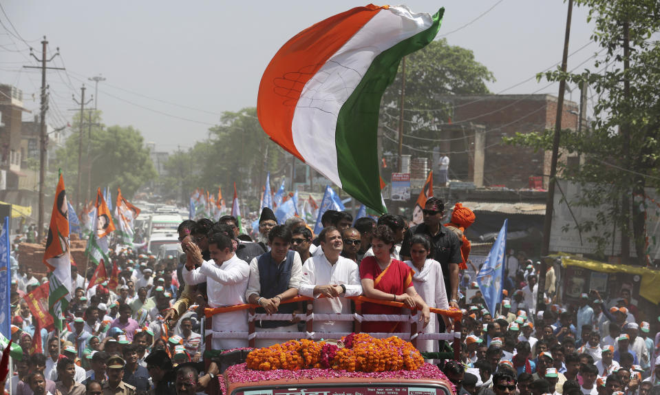 Congress party chief Rahul Gandhi, center in white, accompanied by his sister Priyanka Vadra in red arrives to file his nomination papers for the upcoming general elections in Amethi, Uttar Pradesh state, India, Wednesday, April 10, 2019. Gandhi, the scion of India’s most famous political dynasty, filed nomination papers in the family stronghold of Amethi hoping to hold onto a key seat for a fourth consecutive time in national elections that begin Thursday. (AP Photo/Rajesh Kumar Singh)
