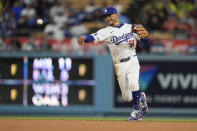 Los Angeles Dodgers shortstop Mookie Betts throws out San Diego Padres' Jackson Merrill at first base on a ground ball during the fourth inning of a baseball game Saturday, April 13, 2024, in Los Angeles. (AP Photo/Marcio Jose Sanchez)