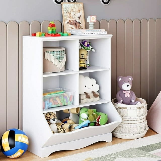 A children's toy cabinet filled with stuffed animals and other toys