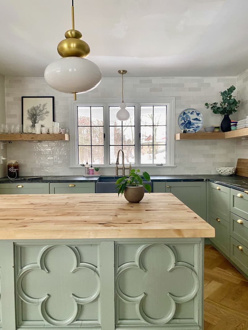 Milk white and brass pendant above kitchen island with quatrefoil detail