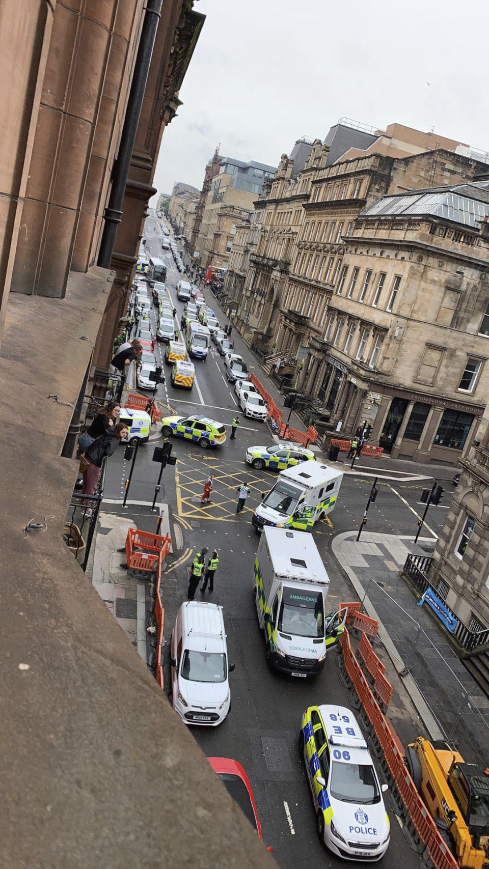 In this photo provided by the Twitter feed of @Milroy1717, emergency services attend the scene of incident in Glasgow, Scotland, Friday June 26, 2020. Police in Glasgow say emergency services are currently dealing with an incident in the center of Scotland's largest city and are urging people to avoid the area. (@Milroy1717 via AP)