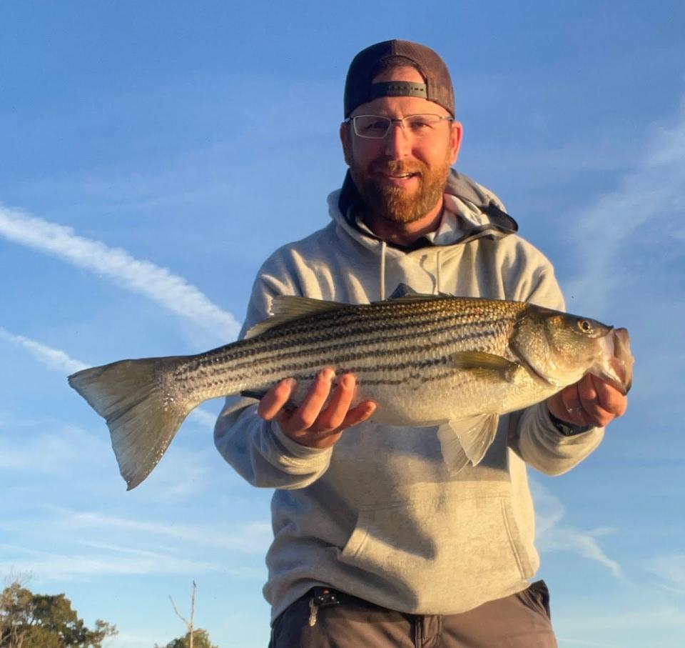 Pete Semaan holds up an Atlantic Striped Bass.