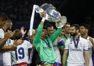 <p>Real Madrid’s Keylor Navas celebrates with the trophy after winning the UEFA Champions League Final </p>