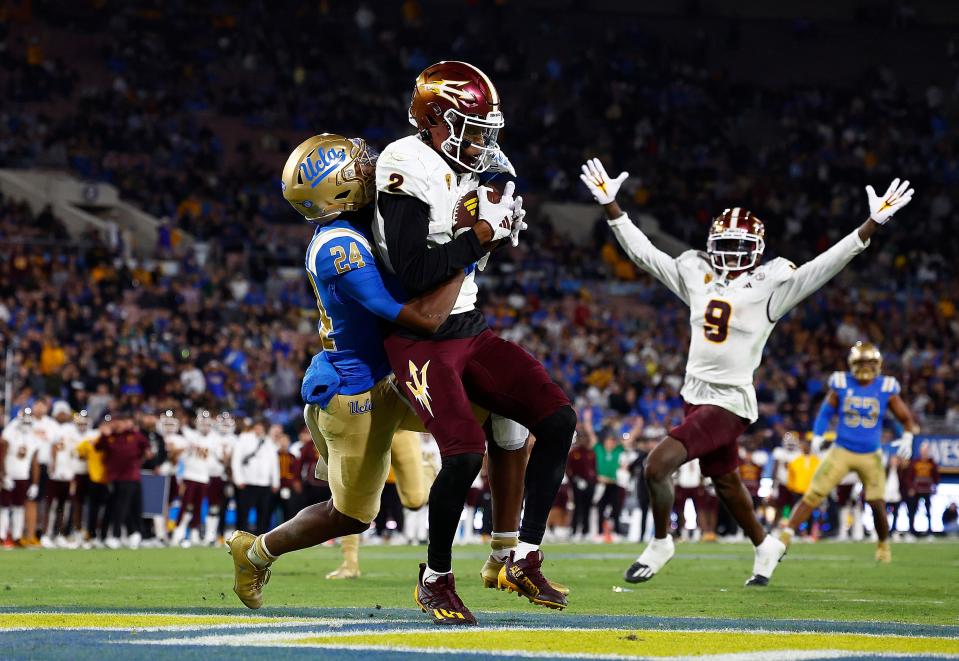 PASADENA, CALIFORNIA - NOVEMBER 11: Elijhah Badger #2 of the Arizona State Sun Devils makes a touchdown pass reception against Jaylin Davies #24 of the UCLA Bruins in the second half at Rose Bowl Stadium on November 11, 2023 in Pasadena, California. (Photo by Ronald Martinez/Getty Images)