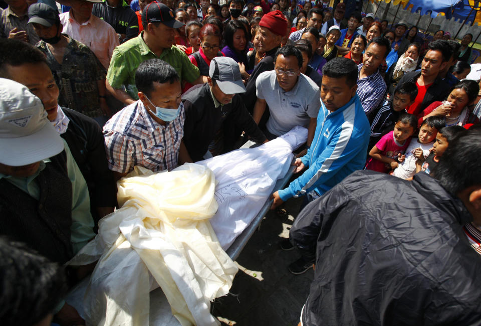 The body of Nepalese mountaineer Ang Kaji Sherpa, killed in an avalanche on Mount Everest, is carried to the Sherpa Monastery in Katmandu, Nepal, Saturday, April 19, 2014. Search teams recovered a 13th body Saturday from the snow and ice covering a dangerous climbing pass on Mount Everest, where an avalanche a day earlier swept over a group of Sherpa guides in the deadliest disaster on the world's highest peak. The Sherpa people are one of the main ethnic groups in Nepal's alpine region, and many make their living as climbing guides on Everest and other Himalayan peaks. (AP Photo/Niranjan Shrestha)