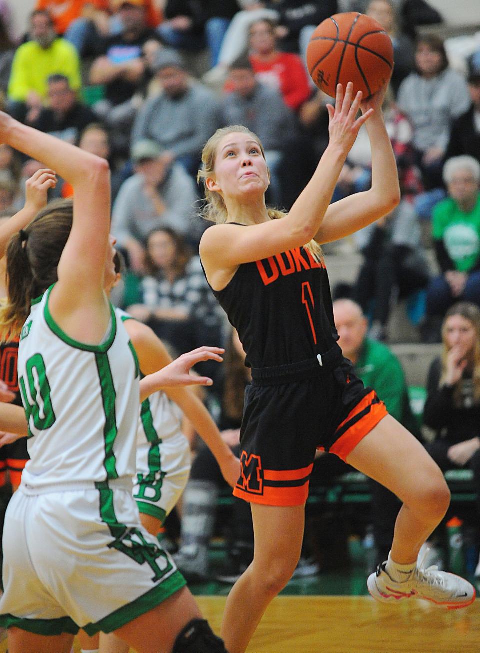 Marlington's Maria Warner shoots a layup as West Branch's Livvie Showalter defends in an Eastern Buckeye Conference game Saturday, December 3, 2022 at the West Branch Field House.