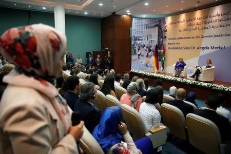 German Chancellor Angela Merkel sits with Dorothea Jecht, Director of German Language Center as she meets with students during her visit to the German Jordanian University near Madaba, Jordan June 21, 2018. REUTERS/Muhammad Hamed