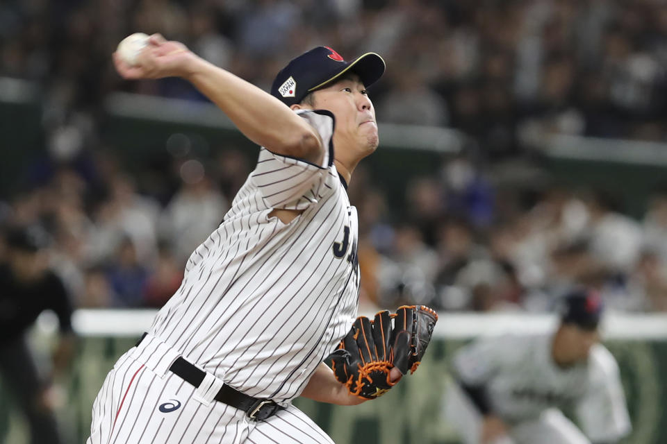 Japan starting pitcher Shun Yamaguchi delivers a pitch against South Korea in the first inning of their Premier12 baseball tournament final game at Tokyo Dome in Tokyo, Sunday, Nov. 17, 2019. (AP Photo/Toru Takahashi)