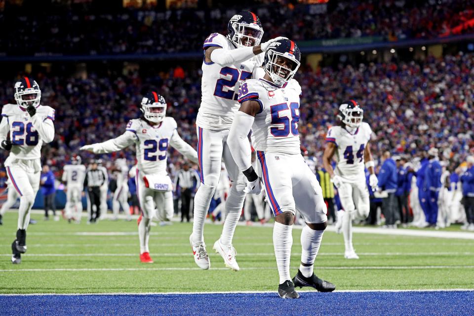 ORCHARD PARK, NEW YORK - OCTOBER 15: Bobby Okereke #58 of the New York Giants celebrates after an interception by teammate Micah McFadden #41 in the second quarter of a game against the Buffalo Bills at Highmark Stadium on October 15, 2023 in Orchard Park, New York. (Photo by Bryan M. Bennett/Getty Images)