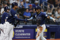 Tampa Bay Rays' Wander Franco, right, celebrates with teammate Christian Bethancourt after scoring against the Houston Astros during the third inning of a baseball game Monday, April 24, 2023, in St. Petersburg, Fla. (AP Photo/Scott Audette)