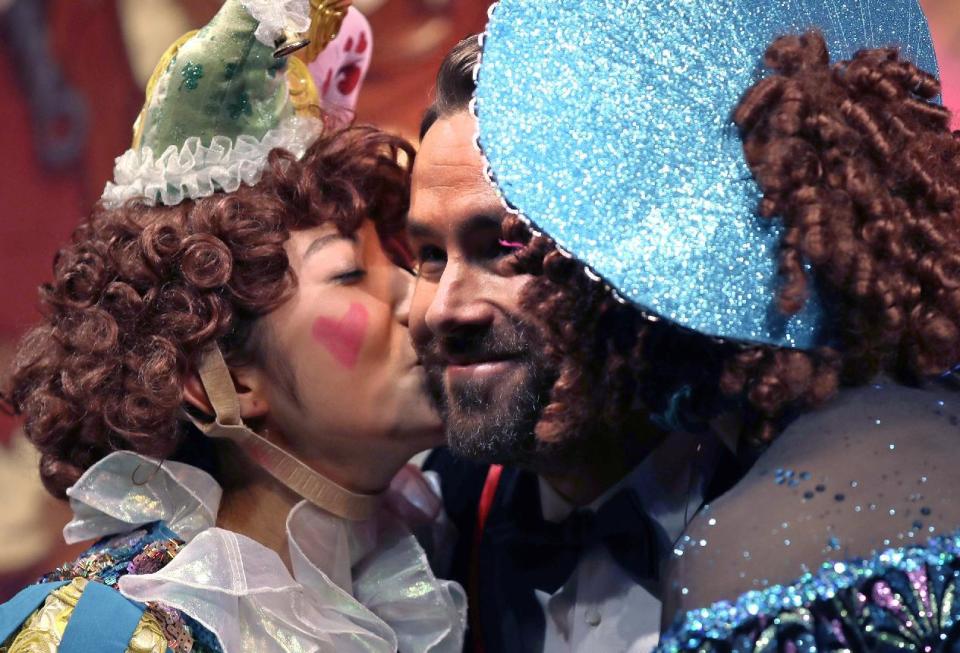 Actor Ryan Reynolds is kissed by two cast members during a roast at Harvard University in Cambridge, Mass., Friday, Feb. 3, 2017. Reynolds was honored as "Man of the Year" by the Hasty Pudding Theatricals at Harvard University. (AP Photo/Charles Krupa)