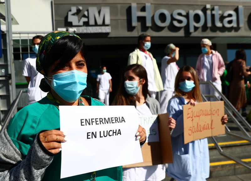 Nurses hold placards during a protest demanding better working conditions outside La Paz hospital amid the outbreak of the coronavirus disease (COVID-19) in Madrid