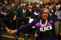 <p>Attendees pray after Stevante Clark, brother of Stephon Clark, disrupted a special city council meeting at Sacramento City Hall on March 27, 2018 in Sacramento, Calif. (Photo: Justin Sullivan/Getty Images) </p>