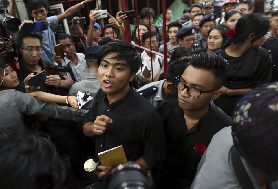 Zayar Lwin, left, member of Student Union and a leader of Peacock Generation "Thangyat" Performance Group, talks as he leaves a township court along with his colleague Paing Phyo Min, right, after their trial Wednesday, Oct. 30, 2019, in Yangon, Myanmar. (AP Photo/Thein Zaw)