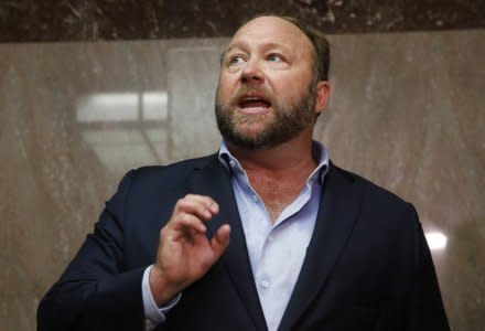 Alex Jones of Infowars talks to the media while visiting the U.S. Senate's Dirksen Senate office building as Twitter CEO Jack Dorsey testifies before a Senate Intelligence Committee hearing on Capitol Hill in Washington, U.S., September 5, 2018. REUTERS/Jim Bourg/File Photo