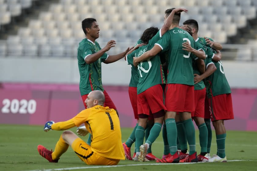 Teamates from Mexico celebrate a goal from Mexico's Sebastian Cordova.