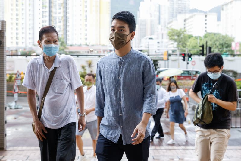 Pro-democracy activist Tat Cheng Tat-hung (C), one of the 47 pro-democracy activists charged with conspiracy to commit subversion under the national security law, arrives West Kowloon Magistrates's Courts building, in Hong Kong