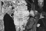 FILE - In this April 14, 1970 file photo, people in Rome look at newspapers headlining the trouble that developed aboard the U.S.'s Apollo 13 mission which led to the cancellation of the attempt to land on the moon. (AP Photo)