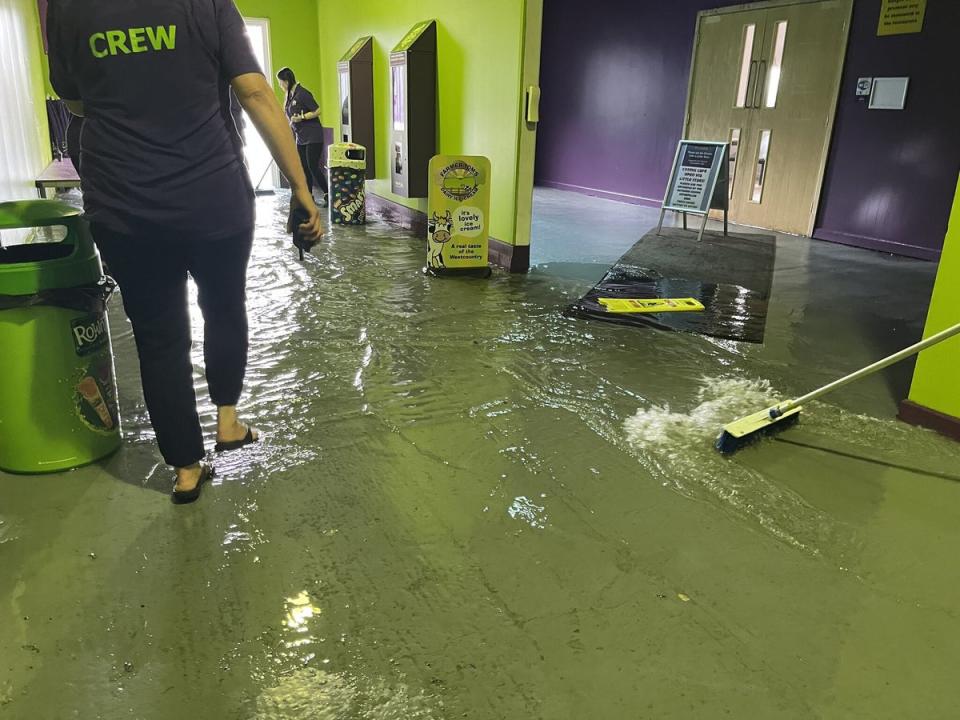 Staff at The Milky Way adventure park in Devon, clear out floodwater after thunderstorms swept across south-west and east England (Steff Gaulter/PA) (PA Wire)