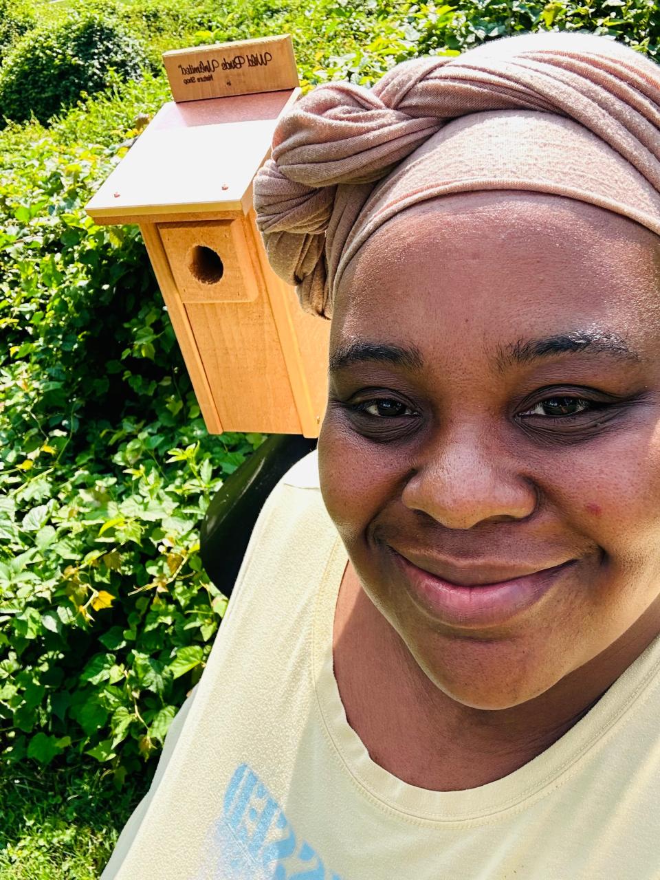 Crystal Cauley poses in front of one of the new bluebird houses installed at Sullivan Park on Aug. 25.