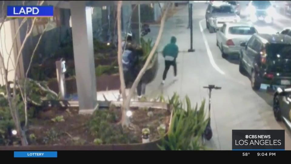 One of the suspects seen here fleeing as the other suspect is still engaged in a tussle with the victim.  / Credit: LAPD