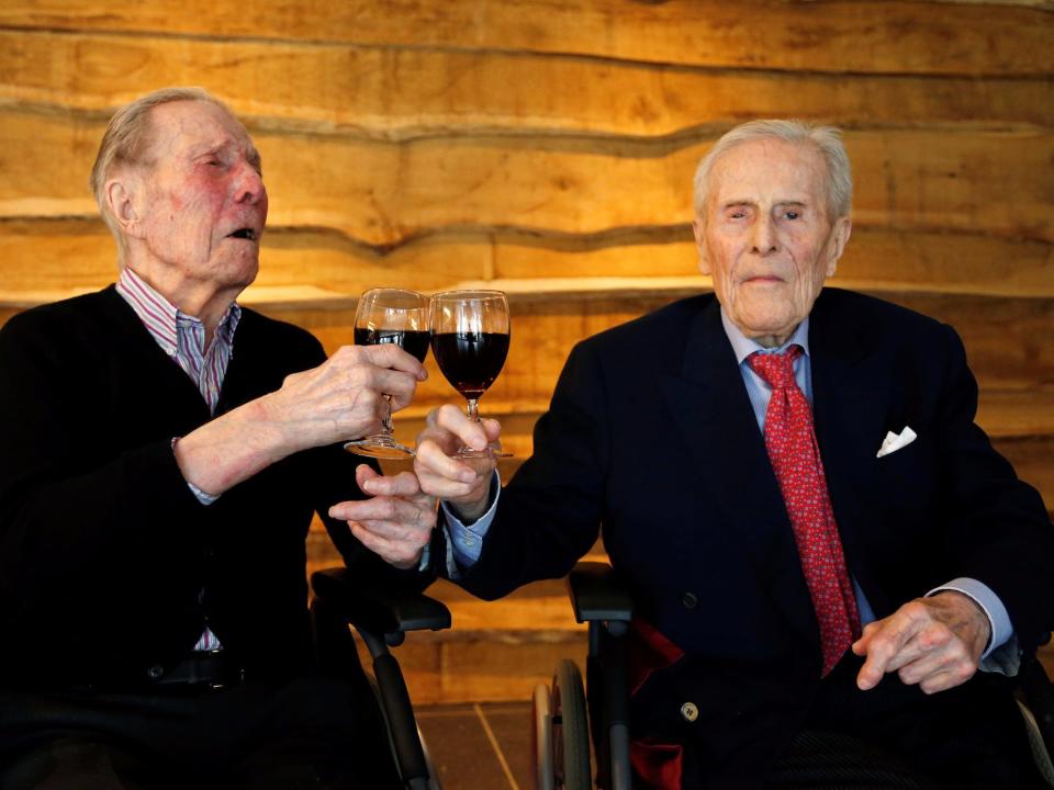 elderly drinking wine brothers
