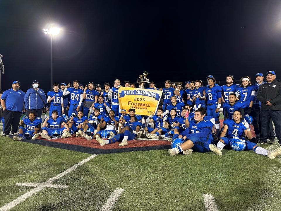 The Hayden Lobos gather for a team shot after beating the Mogollon Mustangs in the Arizona 1A high school football state championship.