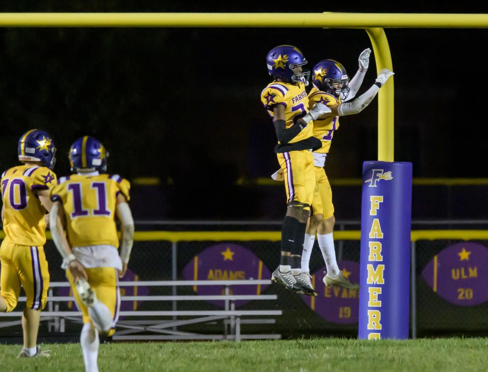 Farmington's Jack Gronewold, right, and Keauntrey Barnes celebrate Gronewold's touchdown reception against Elmwood/Brimfield in the second half of their varsity football game Friday, Sept. 22, 2023 in Farmington. The Farmers defeated the Trojans 30-26.