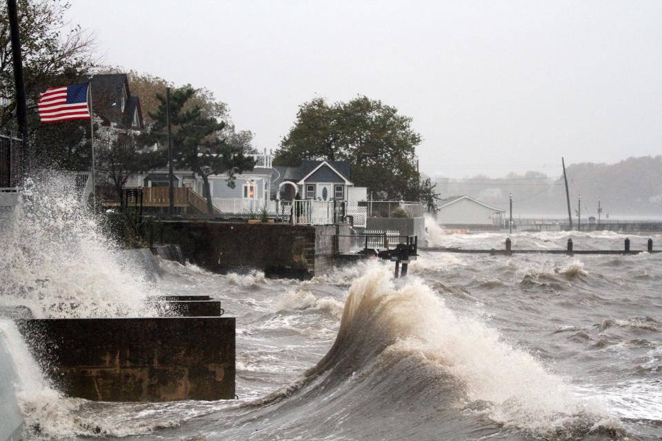 Waves crash into docks and homes near the Keyport Yacht Club on the morning of Oct. 29, 2012. The center of Superstorm Sandy made landfall just hours later.