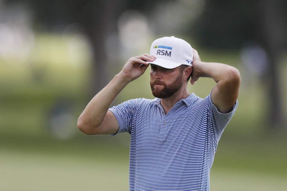 Chris Kirk adjusts his cap on the 14th green during the second round of the Rocket Mortgage Classic golf tournament, Friday, July 3, 2020, at the Detroit Golf Club in Detroit. (AP Photo/Carlos Osorio)