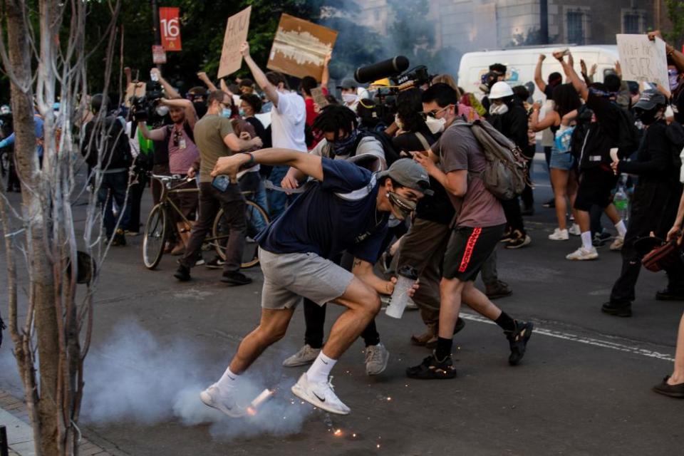 A tear gas canister lands at the feet of protestors near the White House.