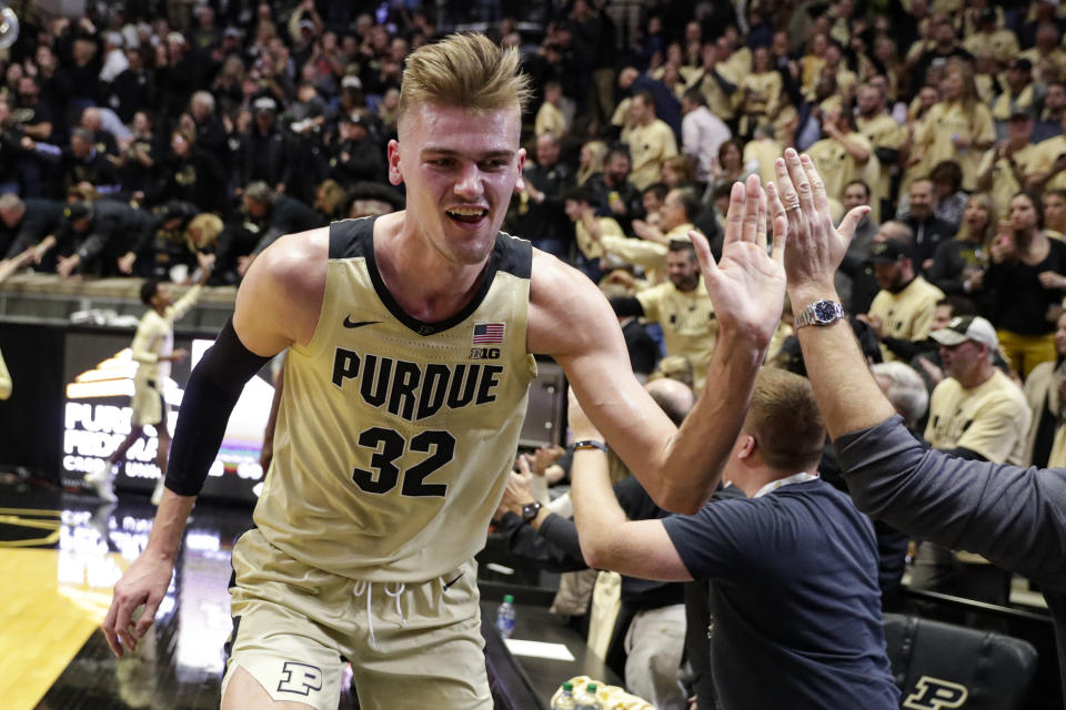 Purdue center Matt Haarms (32) celebrates with fans following the team's NCAA college basketball game against Virginia in West Lafayette, Ind., Wednesday, Dec. 4, 2019. Purdue won 69-40. (AP Photo/Michael Conroy)