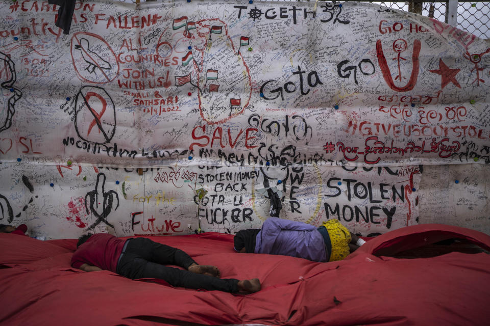 Protesters sleep at their protest site in the morning in Colombo, Sri Lanka, Thursday, July 21, 2022. Sri Lanka's prime minister Ranil Wickremesinghe was elected president Wednesday by lawmakers who opted for a seasoned, veteran leader to lead the country out of economic collapse, despite widespread public opposition. (AP Photo/Rafiq Maqbool)